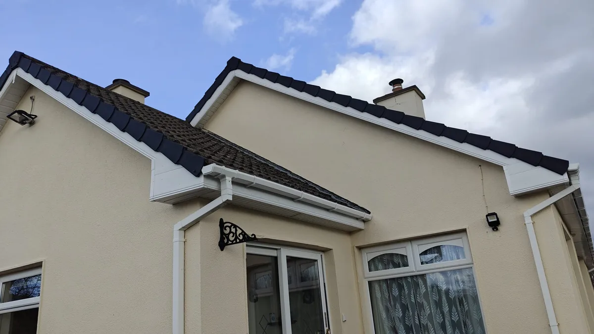 Replacement white fascia and soffit on a cream rendered house