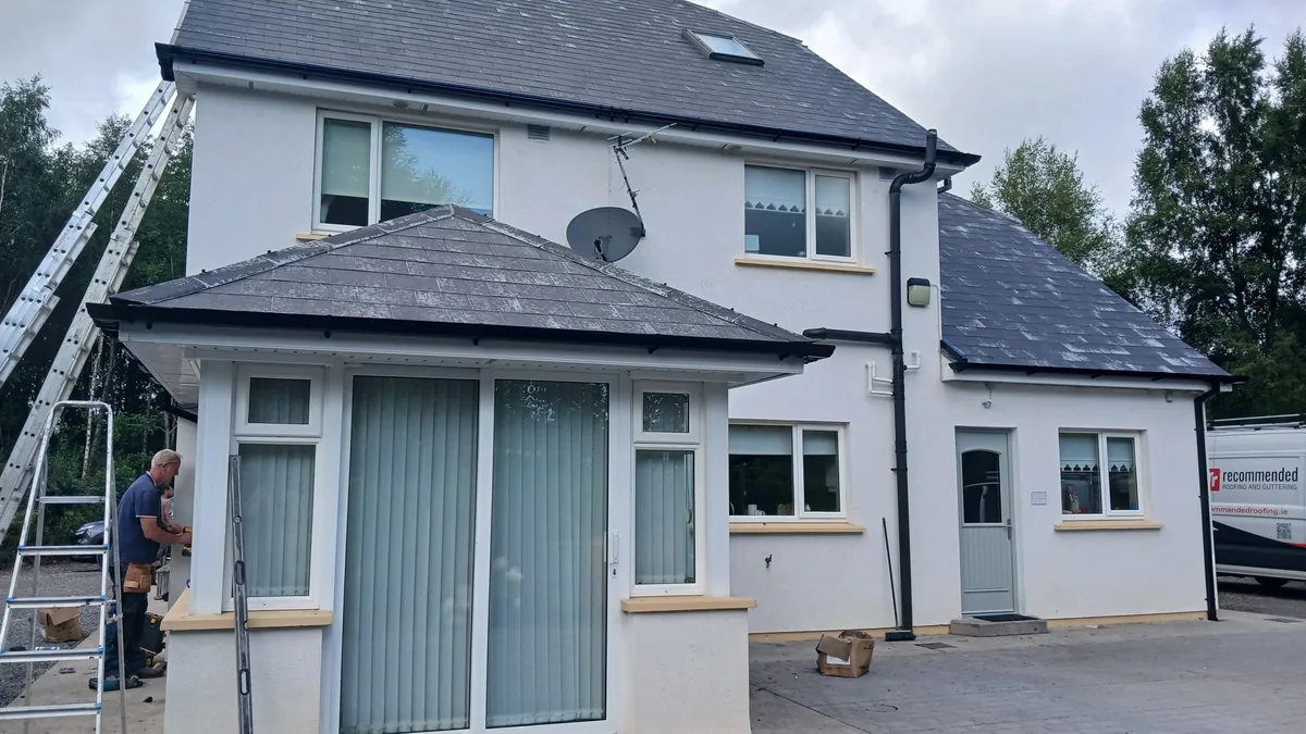 Ladder up to the eaves of a Dublin house for gutter cleaning and clearing